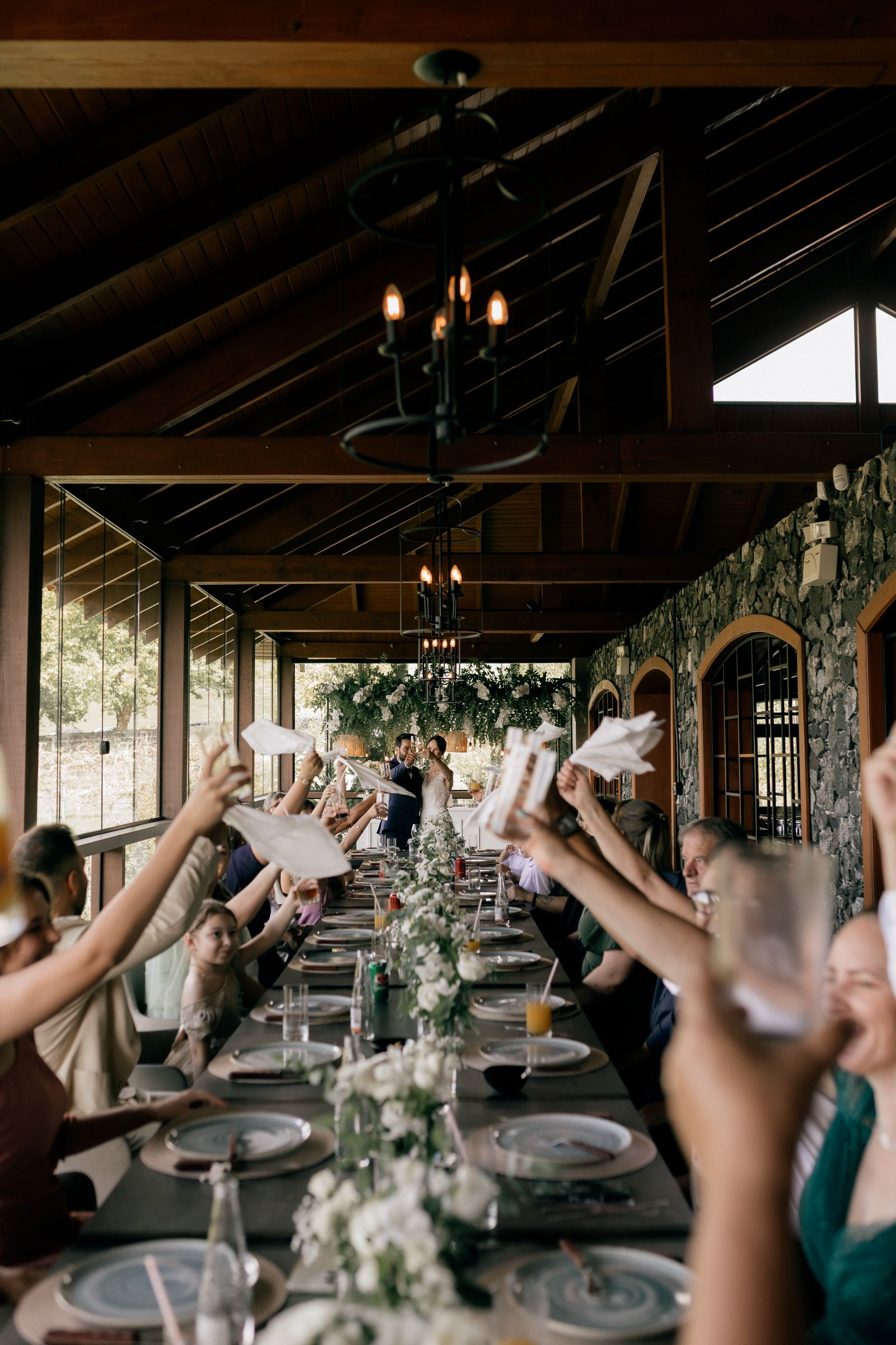Guests raising glasses at a private dinner celebration