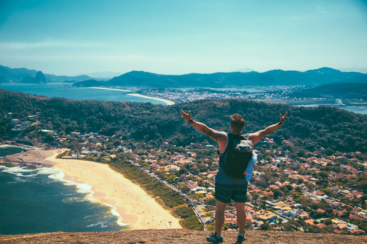 Traveller looking out over a coastal beach town