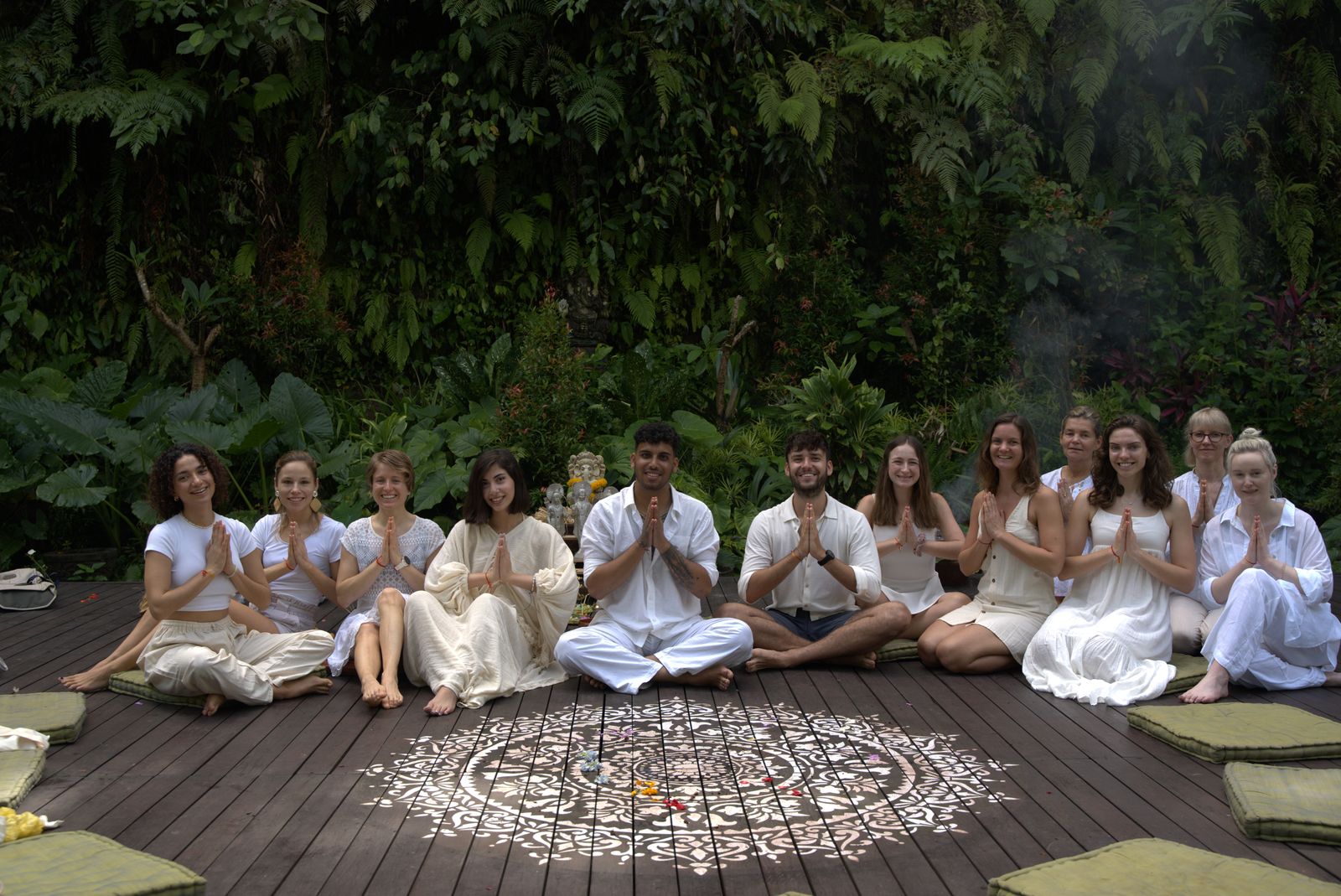Group meditation session surrounded by greenery